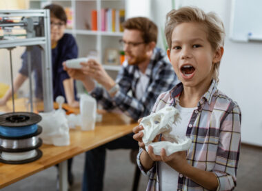 Young learner proudly holding a 3D printed object