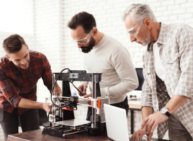 Teacher supporting students with a 3D printing project
